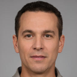 Joyful white adult male with short  brown hair and brown eyes