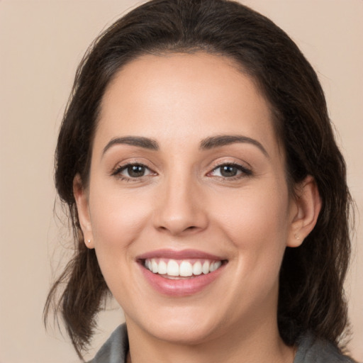 Joyful white young-adult female with medium  brown hair and brown eyes