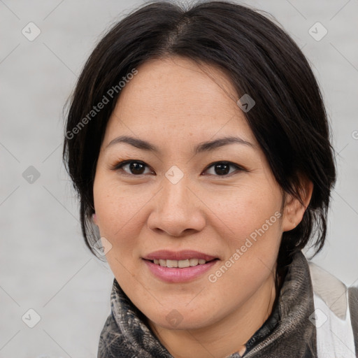 Joyful asian adult female with medium  brown hair and brown eyes