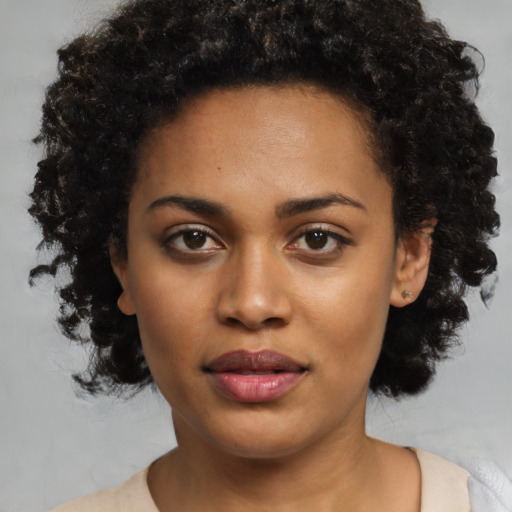 Joyful black young-adult female with medium  black hair and brown eyes