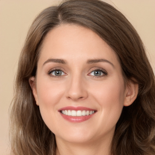 Joyful white young-adult female with long  brown hair and green eyes