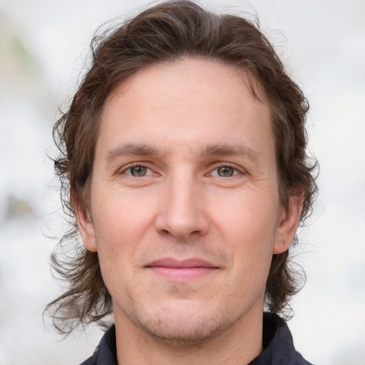 Joyful white young-adult male with medium  brown hair and brown eyes