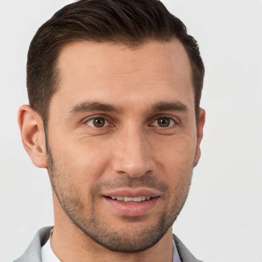 Joyful white young-adult male with short  brown hair and brown eyes