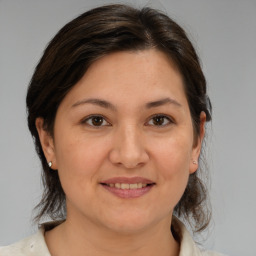 Joyful white adult female with medium  brown hair and brown eyes