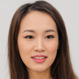 Joyful asian young-adult female with long  brown hair and brown eyes