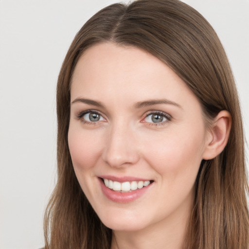 Joyful white young-adult female with long  brown hair and grey eyes