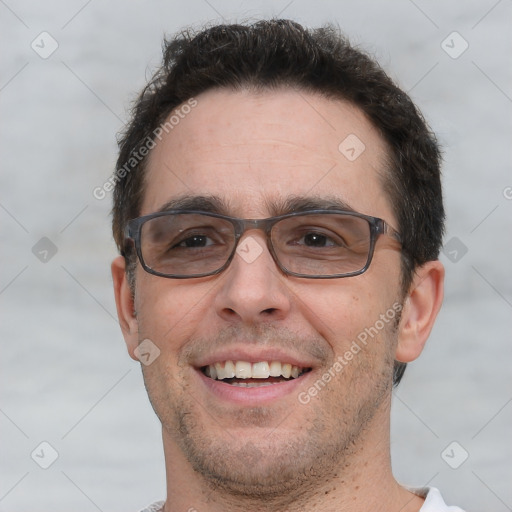 Joyful white adult male with short  brown hair and brown eyes