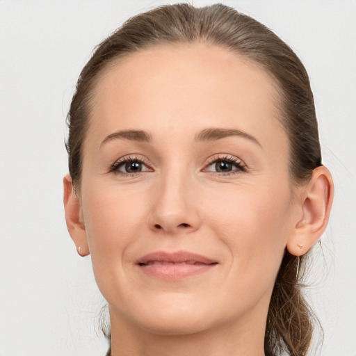 Joyful white young-adult female with medium  brown hair and grey eyes