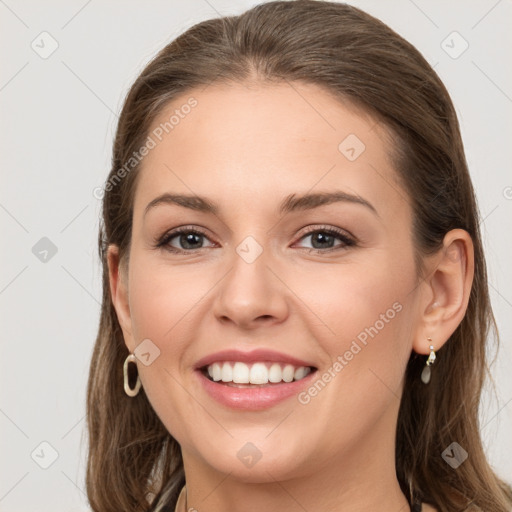 Joyful white young-adult female with long  brown hair and grey eyes