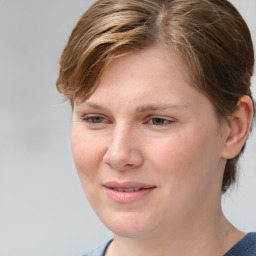 Joyful white young-adult female with medium  brown hair and blue eyes