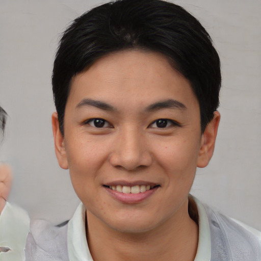 Joyful asian young-adult female with short  black hair and brown eyes