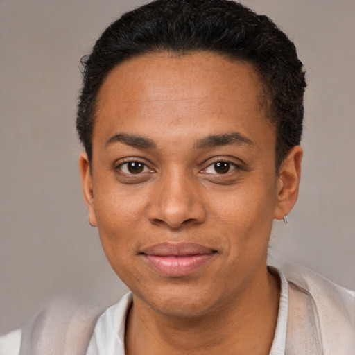 Joyful black young-adult female with short  black hair and brown eyes