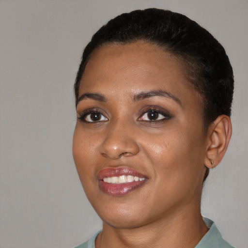 Joyful black young-adult female with short  black hair and brown eyes