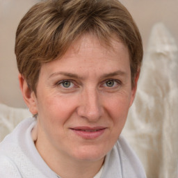 Joyful white adult female with short  brown hair and grey eyes