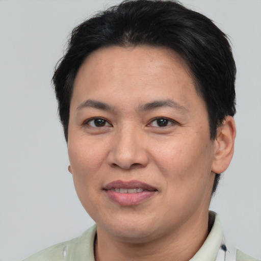 Joyful asian adult female with short  brown hair and brown eyes