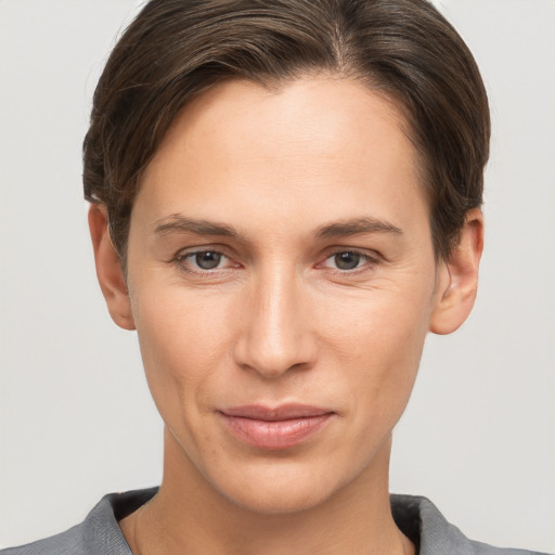 Joyful white young-adult female with short  brown hair and grey eyes