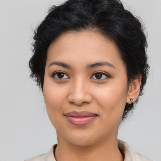 Joyful latino young-adult female with medium  brown hair and brown eyes