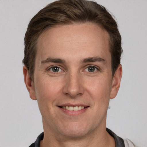 Joyful white adult male with short  brown hair and grey eyes