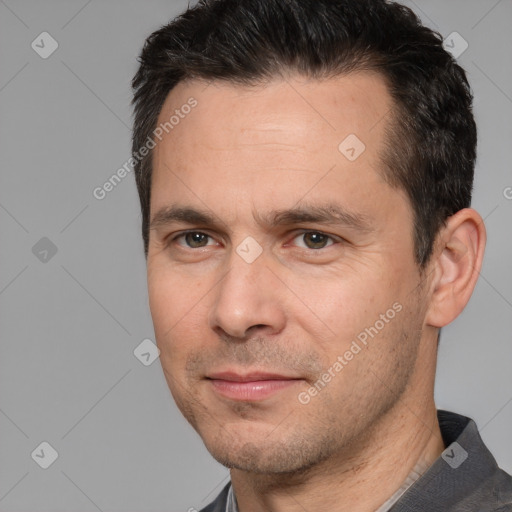 Joyful white adult male with short  brown hair and brown eyes