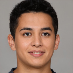 Joyful latino young-adult male with short  brown hair and brown eyes