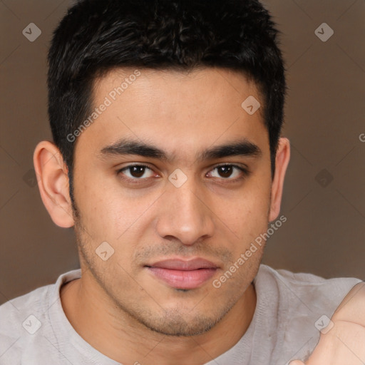 Joyful latino young-adult male with short  brown hair and brown eyes