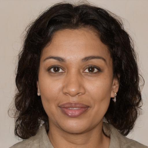 Joyful black adult female with medium  brown hair and brown eyes