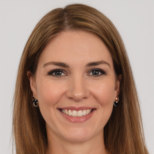 Joyful white young-adult female with long  brown hair and brown eyes