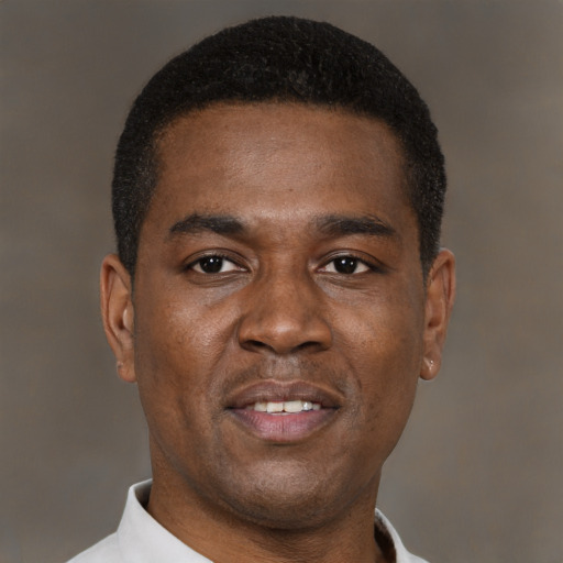 Joyful black young-adult male with short  black hair and brown eyes