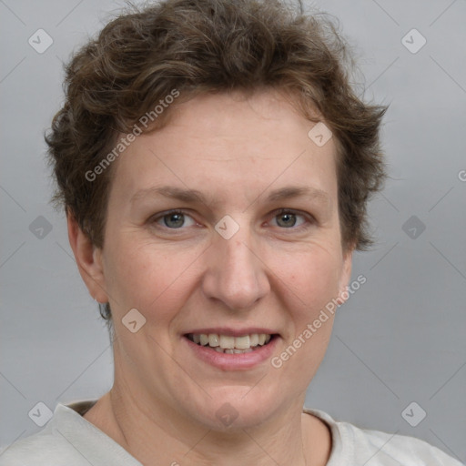 Joyful white adult female with short  brown hair and grey eyes