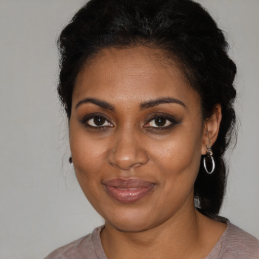 Joyful black young-adult female with medium  brown hair and brown eyes