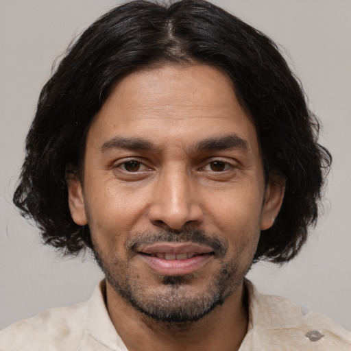 Joyful black adult male with medium  black hair and brown eyes