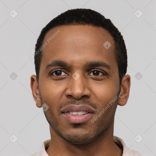 Joyful black young-adult male with short  black hair and brown eyes