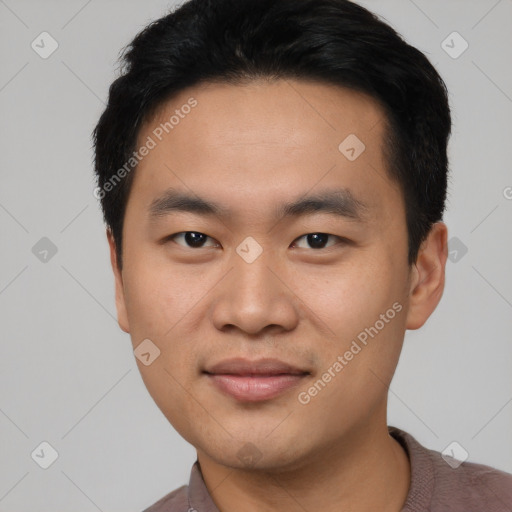 Joyful asian young-adult male with short  black hair and brown eyes