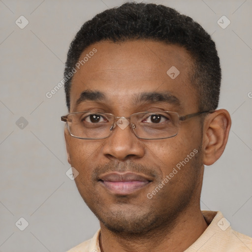 Joyful black adult male with short  black hair and brown eyes