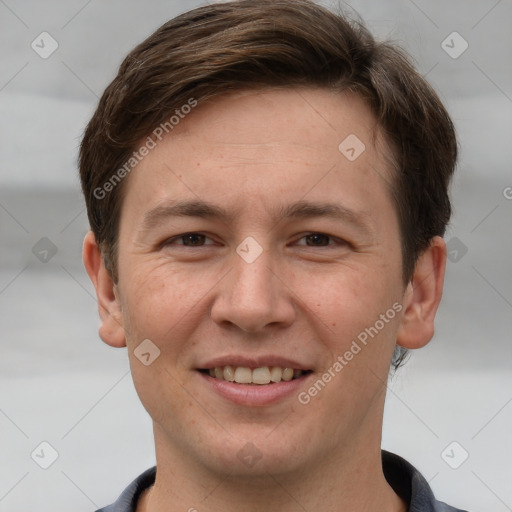 Joyful white adult male with short  brown hair and grey eyes