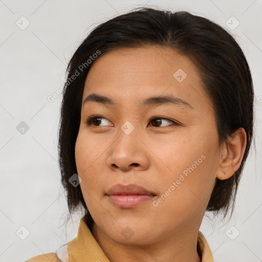 Joyful asian young-adult female with medium  brown hair and brown eyes