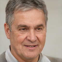 Joyful white middle-aged male with short  gray hair and brown eyes