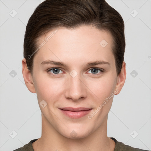 Joyful white young-adult female with short  brown hair and grey eyes