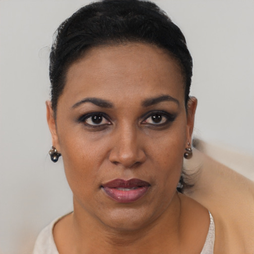 Joyful latino young-adult female with short  black hair and brown eyes