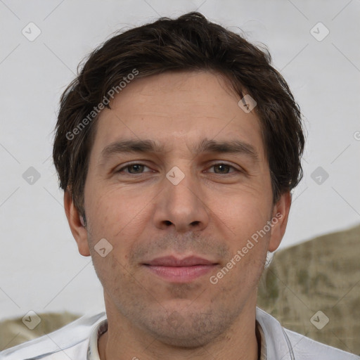 Joyful white adult male with short  brown hair and brown eyes