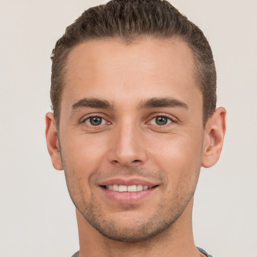 Joyful white young-adult male with short  brown hair and brown eyes