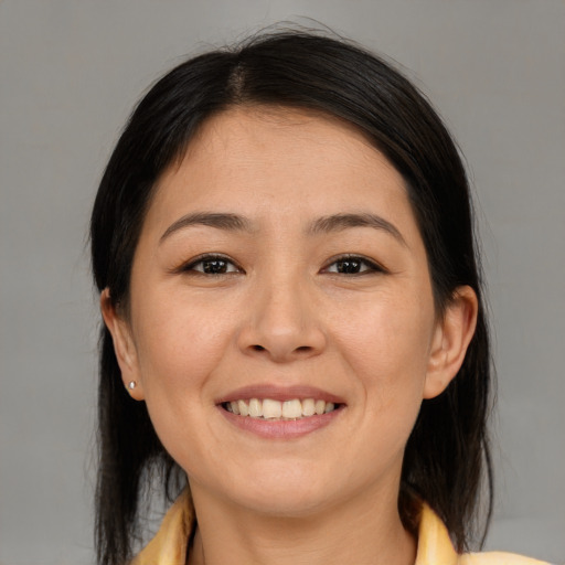 Joyful asian young-adult female with medium  brown hair and brown eyes