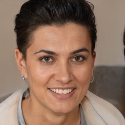 Joyful white adult female with short  brown hair and brown eyes