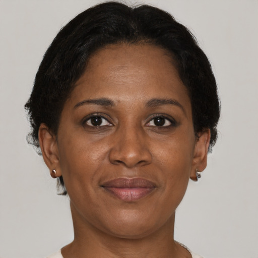 Joyful black adult female with short  brown hair and brown eyes