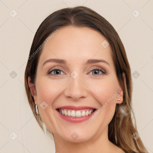 Joyful white young-adult female with long  brown hair and blue eyes