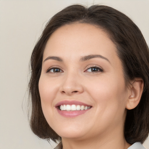 Joyful white young-adult female with medium  brown hair and brown eyes