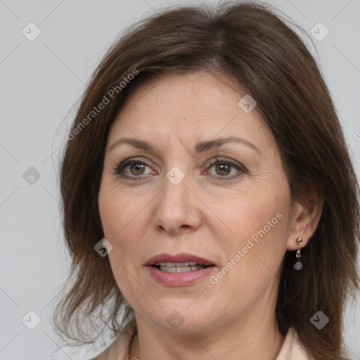 Joyful white adult female with medium  brown hair and brown eyes