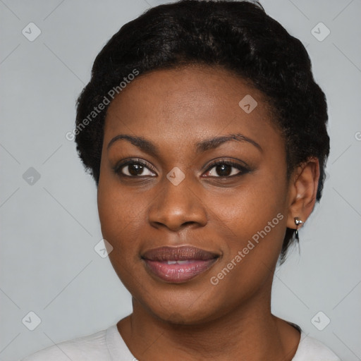 Joyful black young-adult female with short  black hair and brown eyes