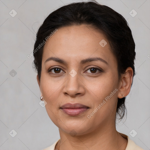 Joyful latino young-adult female with short  black hair and brown eyes