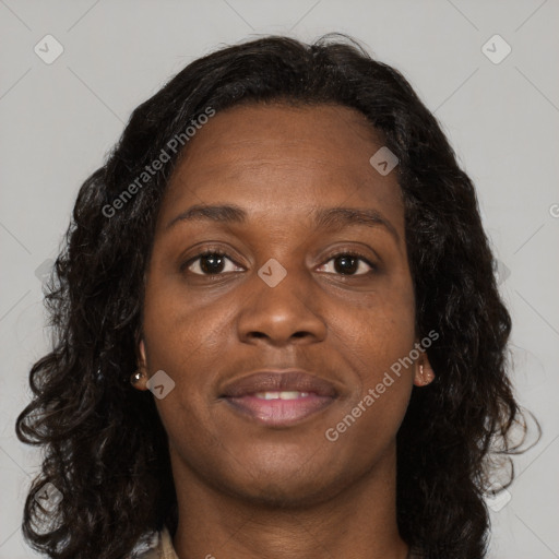 Joyful black young-adult female with long  brown hair and brown eyes